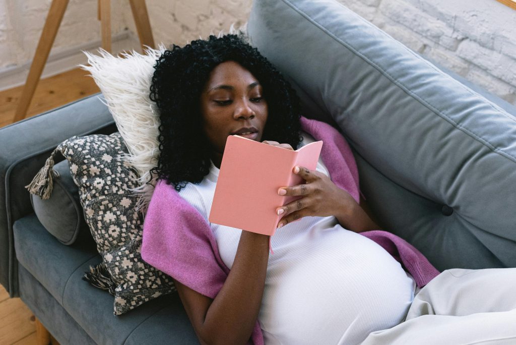 An expectant mother reading and preparing for birth