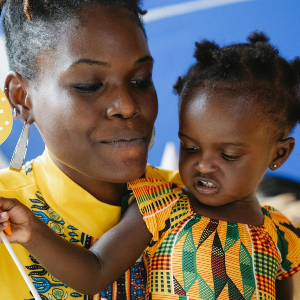 A smiling mother and child in matching kitenge prints