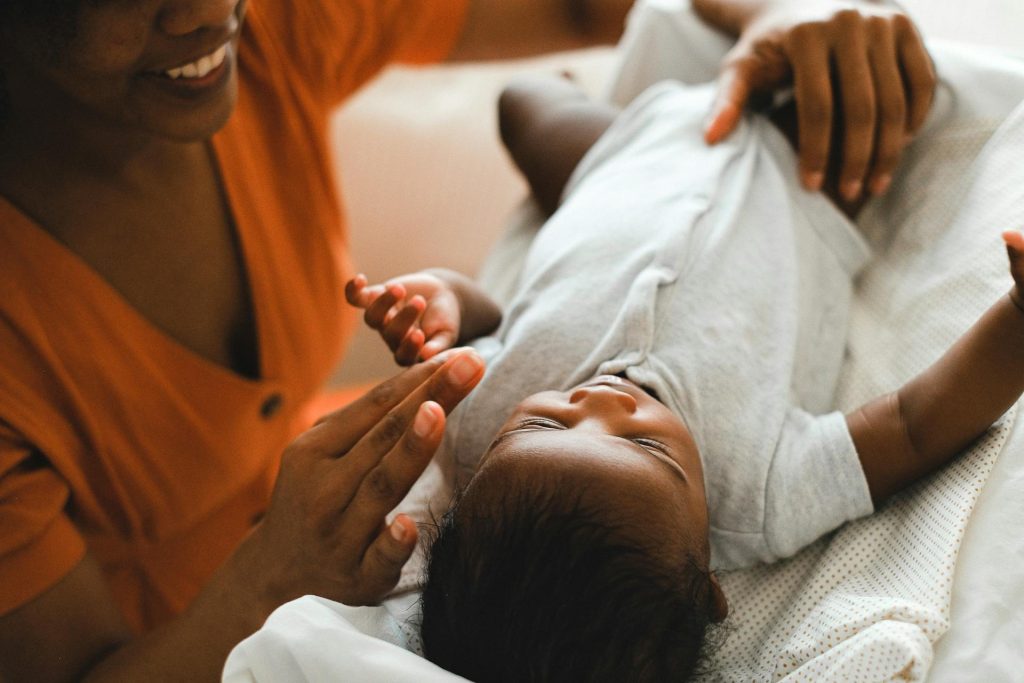 A caregiver attending to a baby during the day