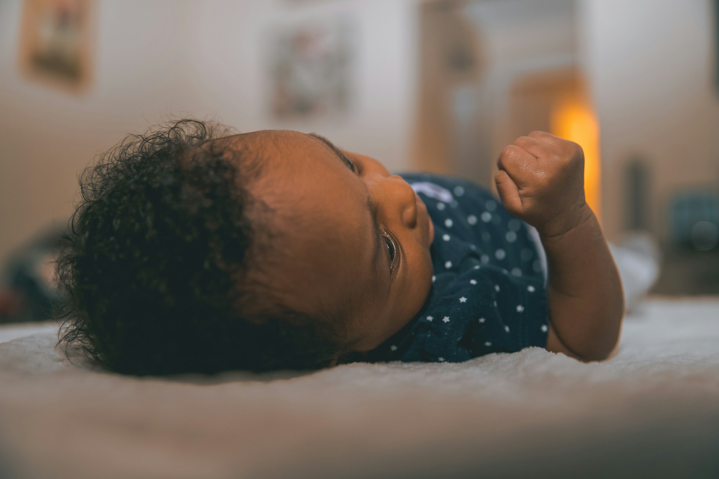 A newborn baby resting on a soft blanket