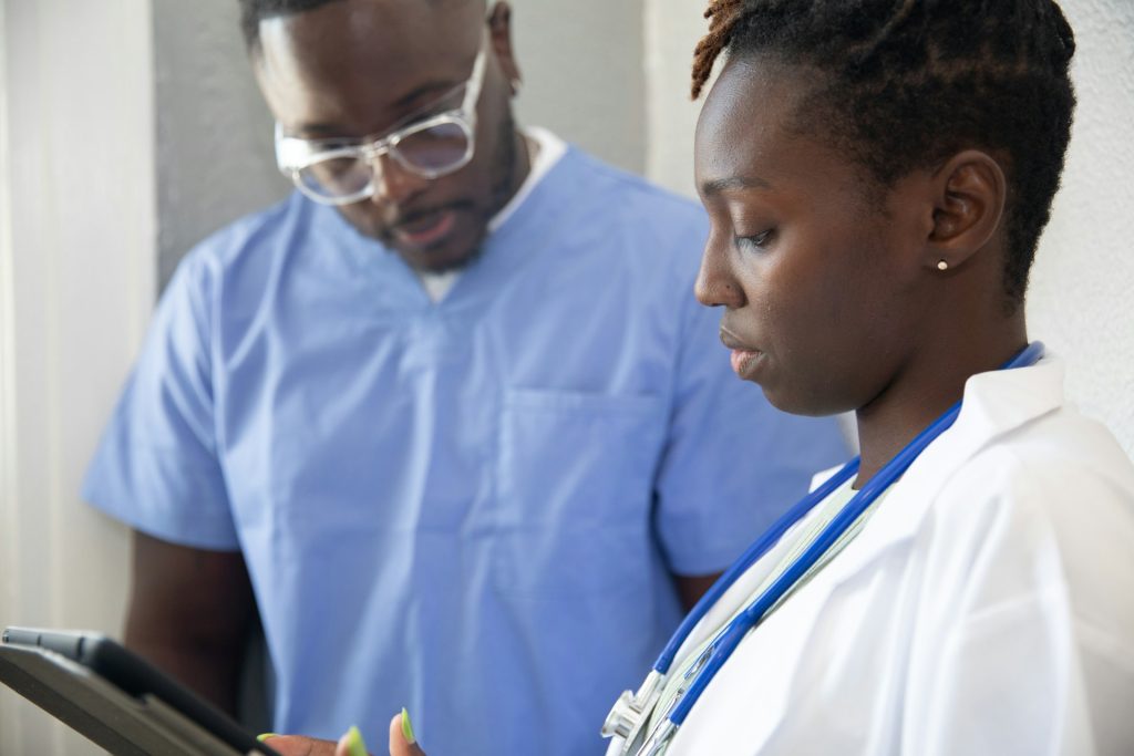 Two nurses in scrubs ready to help