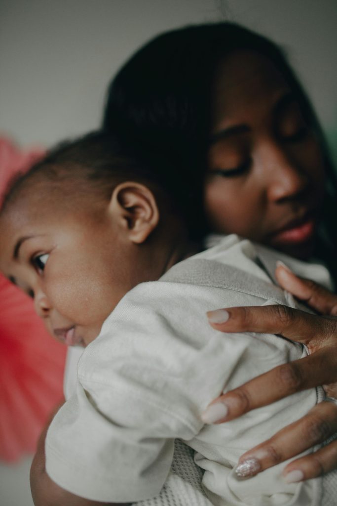 A mother cradling her infant