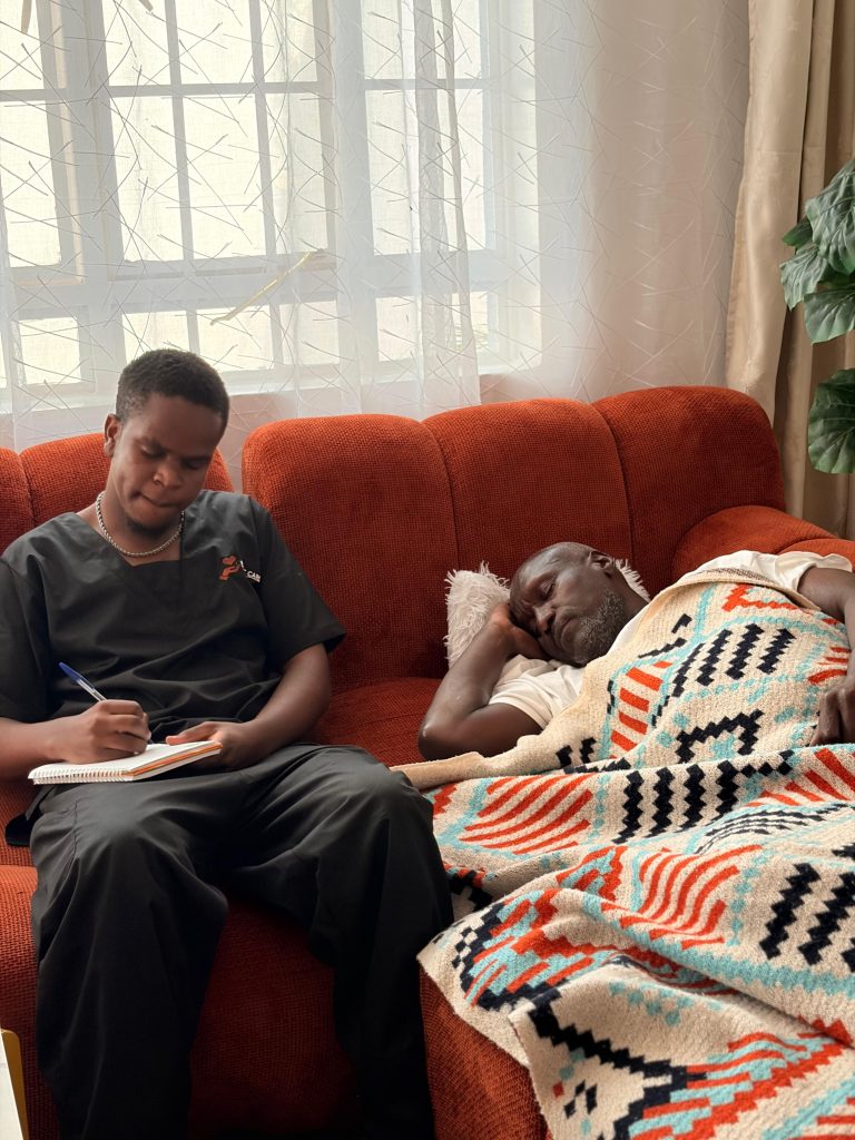 Premac Care caregiver supporting an older man at home.