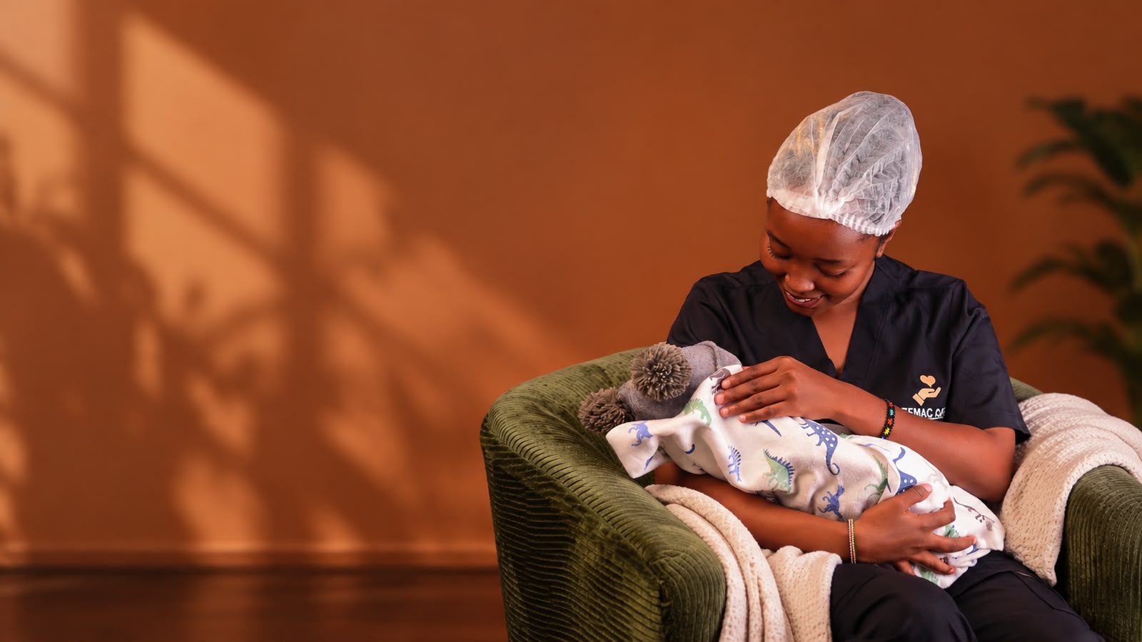 Premac Care nurse gently holding a newborn